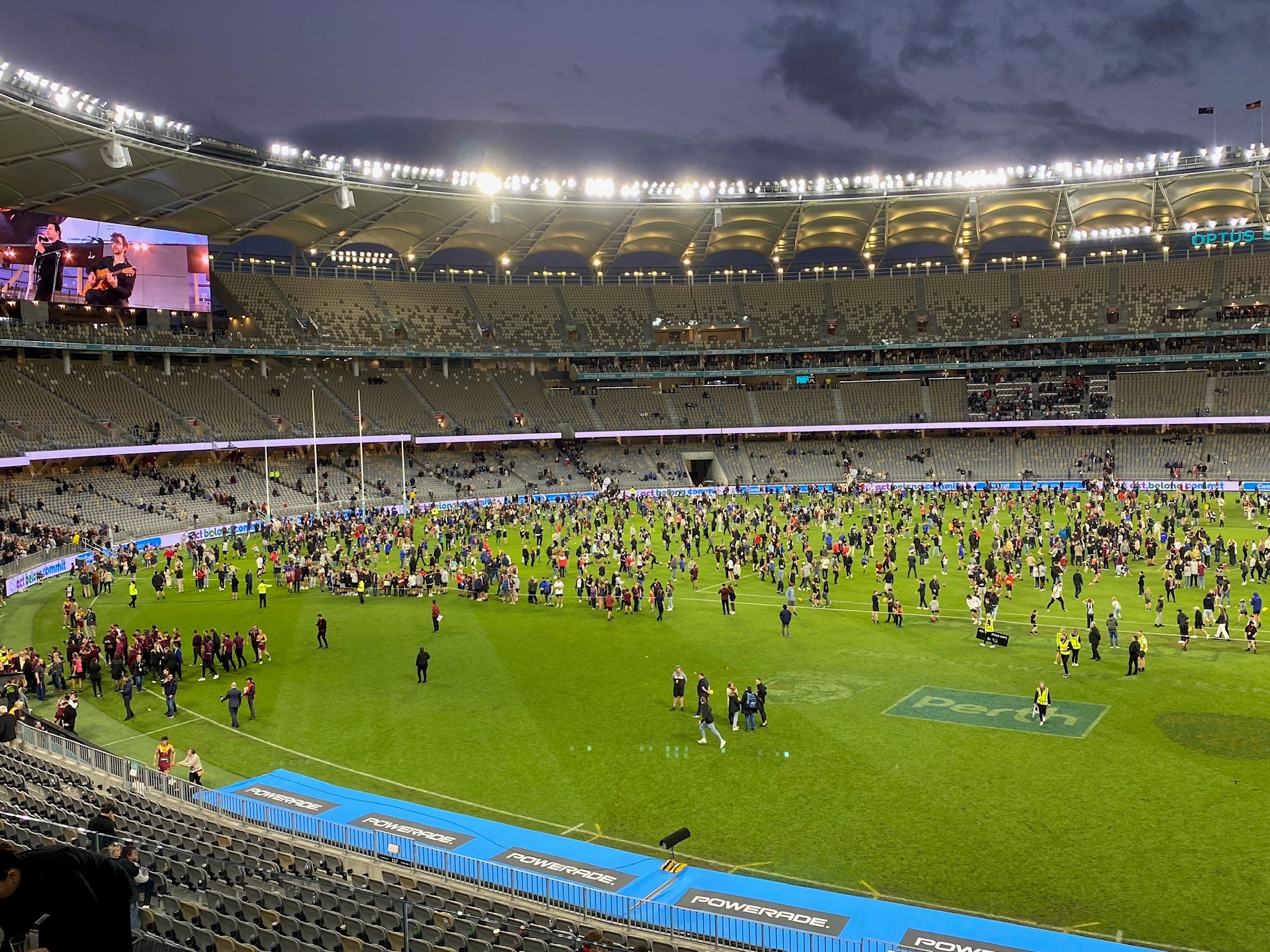 a crowd of people participating in Kick2Kick football activity on Optus Stadium Field.
