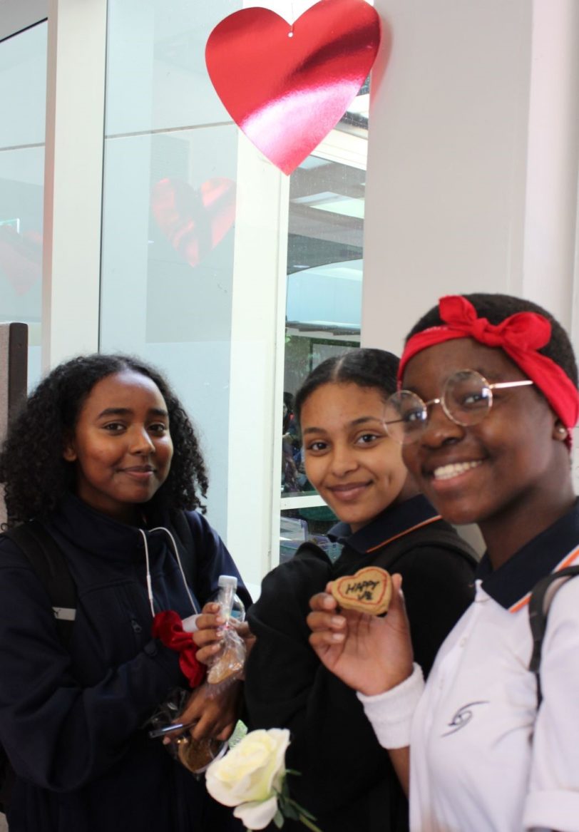 three female high school students pose with cookies