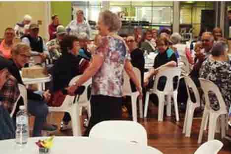 A group of over 55's gather in a community hall